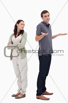 Man shrugged his shoulders back to back with woman