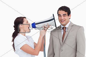 Saleswoman with megaphone yelling at colleague