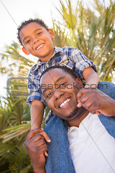 Mixed Race Father and Son Playing Piggyback