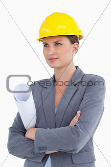 Female architect with plans and helmet on