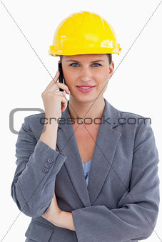 Smiling female architect on her cellphone