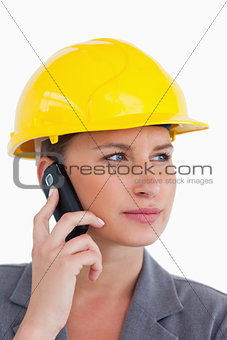 Close up of female architect on her cellphone with helmet on