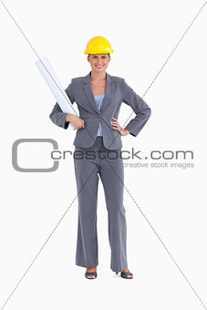 Smiling female architect with plans and helmet on