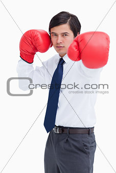 Young tradesman with boxing gloves striking