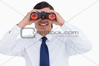 Close up of smiling tradesman looking through spy glass