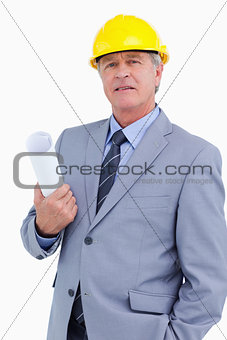 Confident mature architect with helmet and plans
