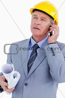 Mature architect on his mobile phone