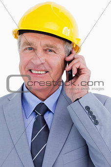 Close up of smiling mature architect on his cellphone