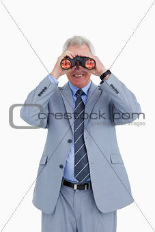 Smiling mature tradesman looking through spy glass