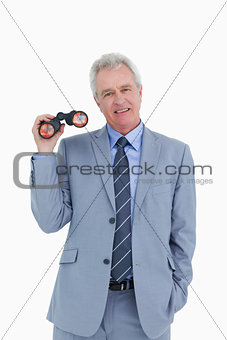 Smiling mature tradesman with spy glass