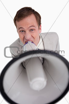 Businessman shouting through megaphone