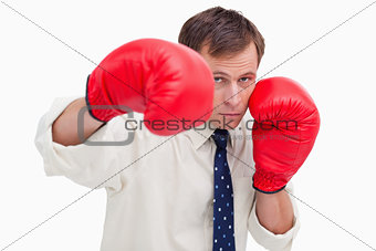 Striking businessman with boxing gloves