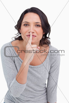 Close up of young woman asking for silence