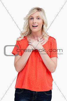 Teenager looking surprised while crossing her hands on her chest
