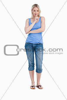 Blonde woman telling to be quiet while crossing her arms