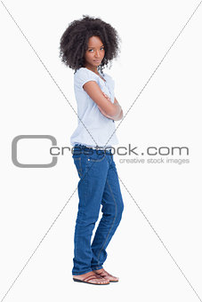 Side view of a serious young woman crossing her arms