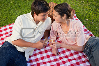 Two friends smiling towards each other during a picnic
