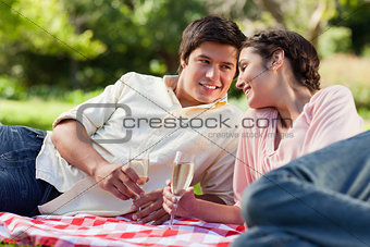 Man smiling as he looks at his friend during a picnic