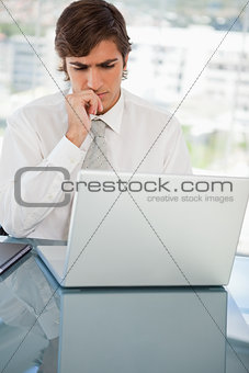 Serious businessman on his laptop