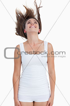 Smiling woman standing with her hair elevated