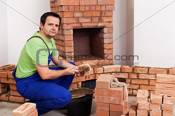 Masonry worker building fireplace