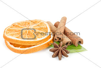 Star Anise, cinnamon and dried orange and green leave on white