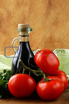 bottle of balsamic vinegar and fresh tomatoes