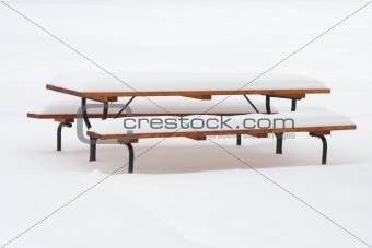 picnic table covering with snow