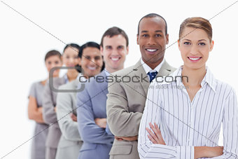 Close-up of smiling people dressed in suits crossing their arms 