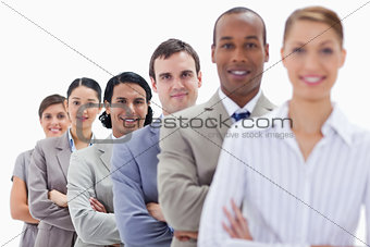 Close-up of workmates dressed in suits crossing their arms in a 