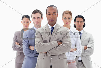 Close-up of a serious business team crossing their arms