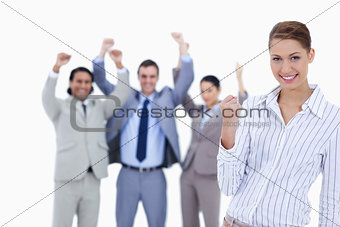 Secretary smiling and clenching her fist with enthusiastic busin
