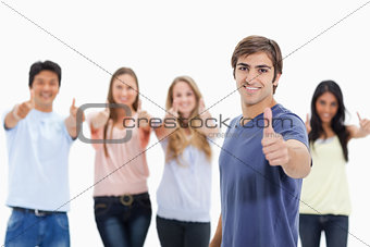 People smiling and approving with one of them in foreground