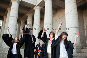 Graduates dancing in togas