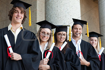 Close-up of five graduates students posing
