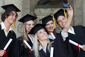Close-up of five graduates taking a picture of themselves