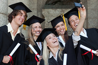 Close-up of happy graduates taking a picture of themselves