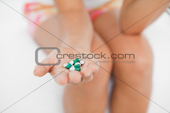 Close-up on a girl's hand holding a lot of medicine