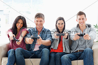 A group with arms out smiling as they play games together