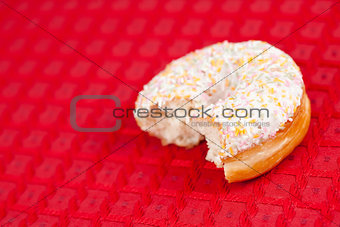 Half doughnut on a red tablecloth