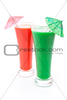 Two full glasses with cocktail umbrella