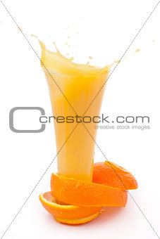 orange peel surrounded around a overflowing glass 