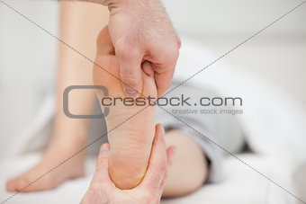 Practitioner placing his thumb on a foot