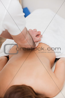 Therapist massaging the back of his patient