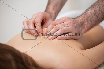 Chiropractor massaging his patient while using his fingertips