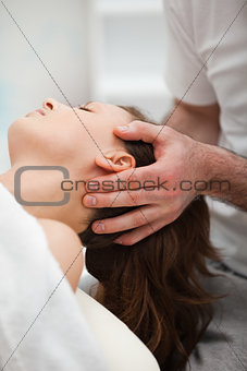 Neck of a woman being manipulating by a therapist