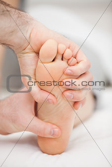 Foot being held by two hands