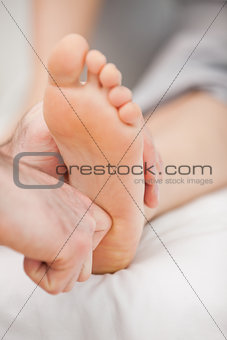 The ball of a foot being massaged