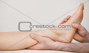 Chiropodist holding the ankle of a patient
