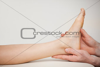 Chiropodist holding the foot of a patient